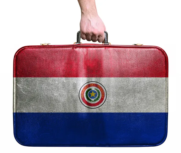 Toeristische hand met vintage lederen reistas met vlag voor par — Stockfoto