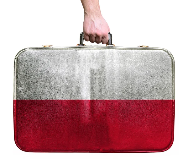 Tourist hand holding vintage leather travel bag with flag of Pol — Stock Photo, Image