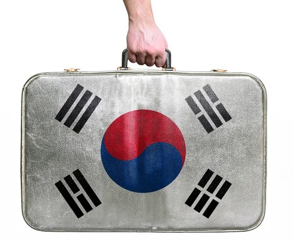 Tourist hand holding vintage leather travel bag with flag of Sou — Stock Photo, Image