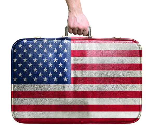 Tourist hand holding vintage leather travel bag with flag of Uni — Stock Photo, Image
