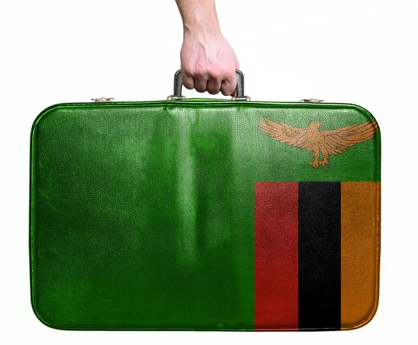 Tourist hand holding vintage leather travel bag with flag of Zam — Stock Photo, Image