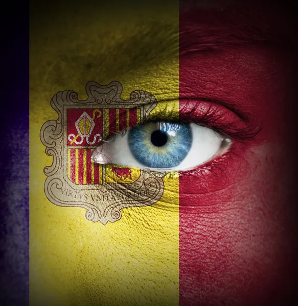 Human face painted with flag of Andorra — Stock Photo, Image