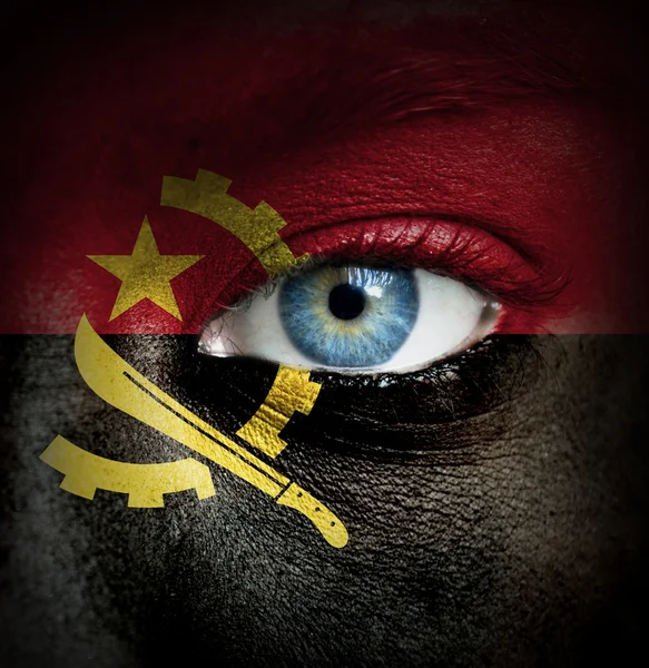 Human face painted with flag of Angola — Stock Photo, Image