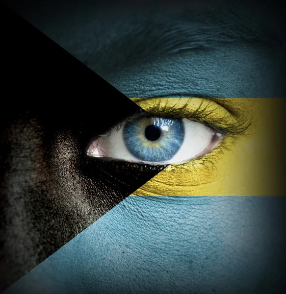 Human face painted with flag of Bahamas — Stock Photo, Image