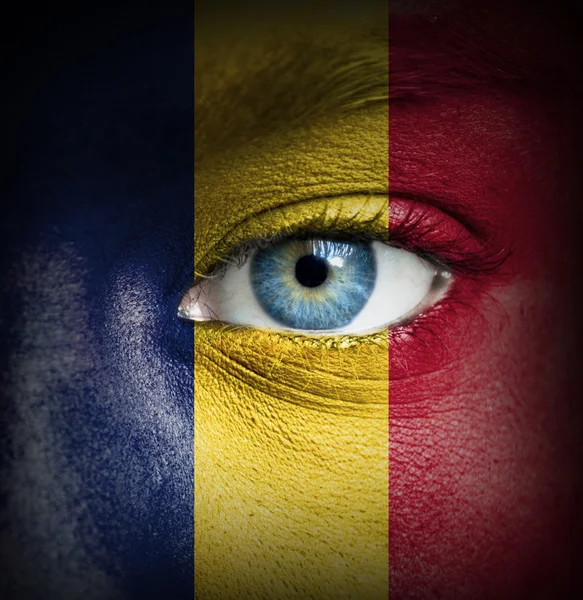 Human face painted with flag of Chad — Stock Photo, Image