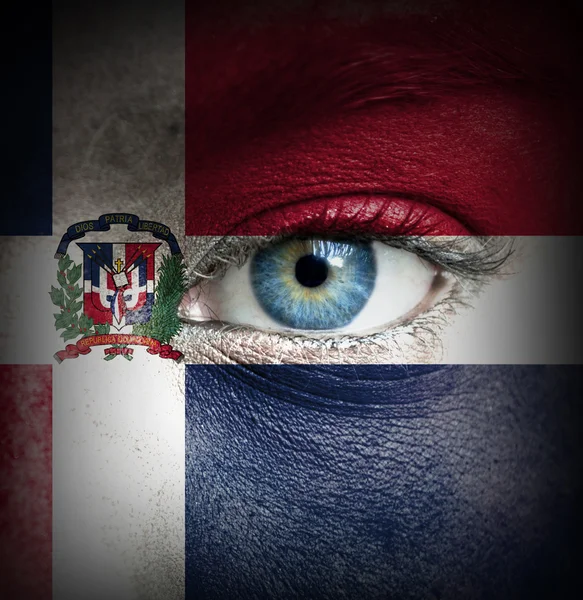 Human face painted with flag of Dominican Republic — Stock Photo, Image
