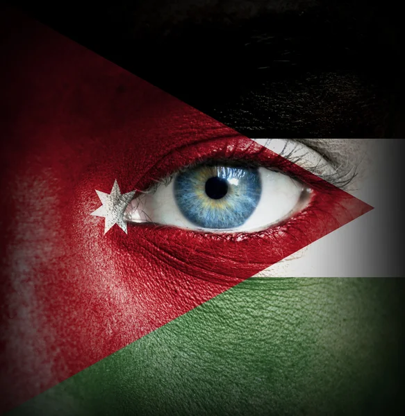 Human face painted with flag of Jordan — Stock Photo, Image