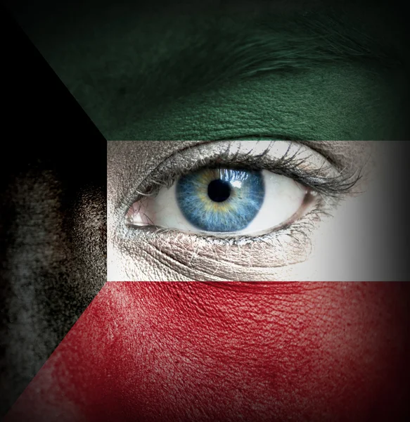 Human face painted with flag of Kuwait — Stock Photo, Image