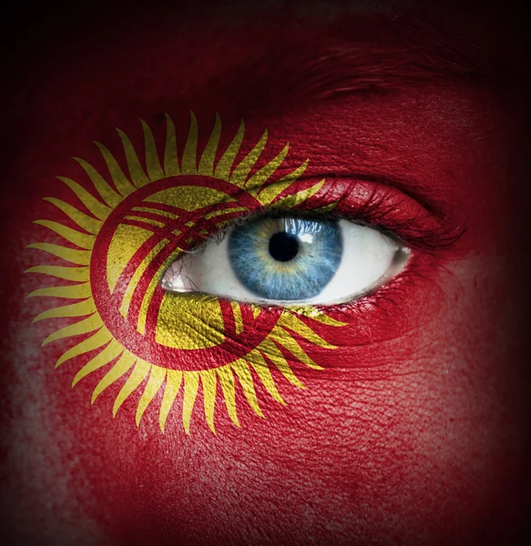Human face painted with flag of Kyrgyzstan — Stock Photo, Image