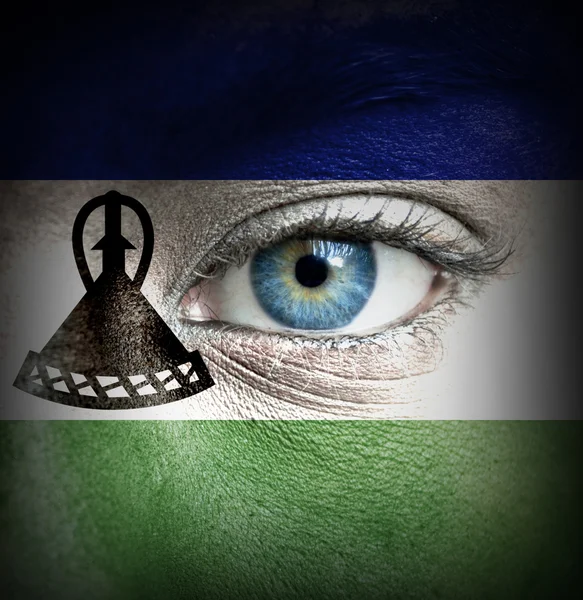 Human face painted with flag of Lesotho — Stock Photo, Image