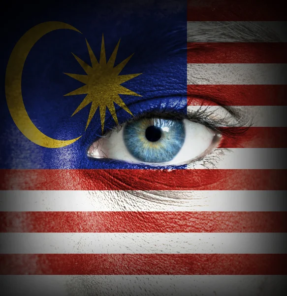 Cara humana pintada con bandera de Malasia — Foto de Stock