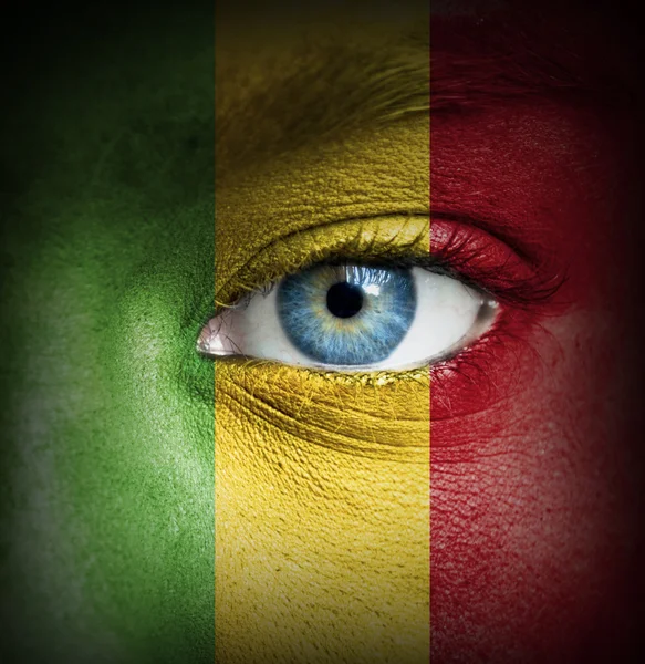 Human face painted with flag of Mali — Stock Photo, Image