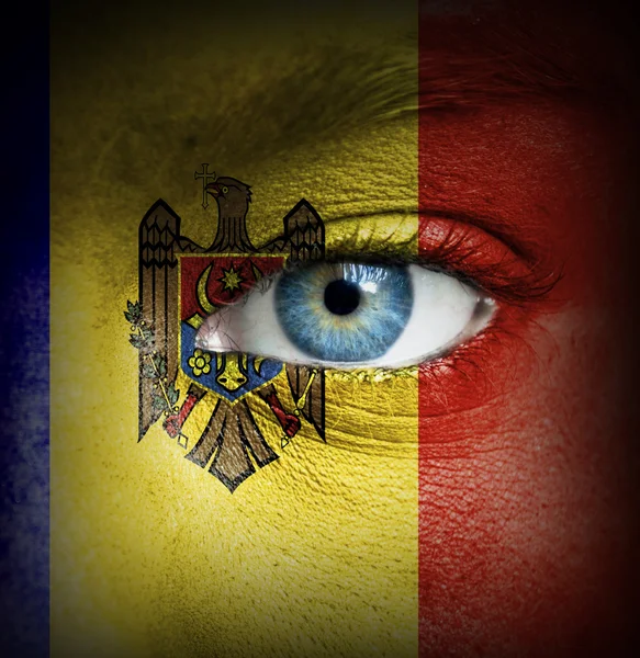 Human face painted with flag of Moldova — Stock Photo, Image