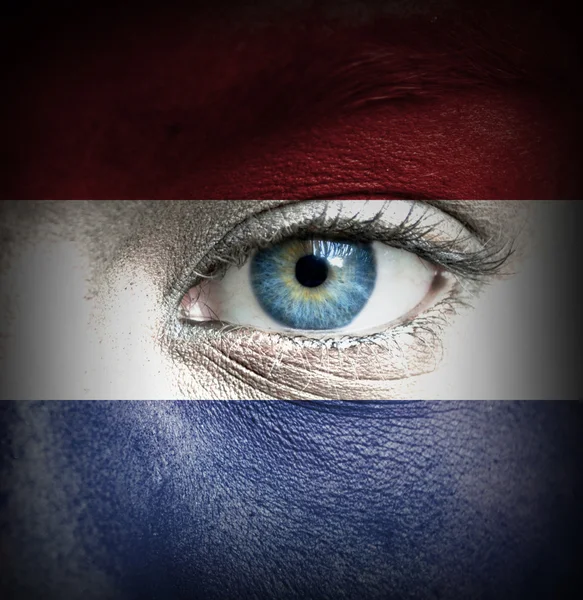 Human face painted with flag of Netherlands — Stock Photo, Image