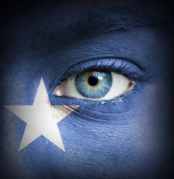 Human face painted with flag of Somalia — Stock Photo, Image