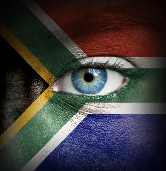 Mänskligt ansikte målade med flagga i Sydafrika — Stockfoto