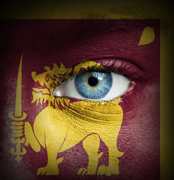 Human face painted with flag of Sri Lanka — Stock Photo, Image