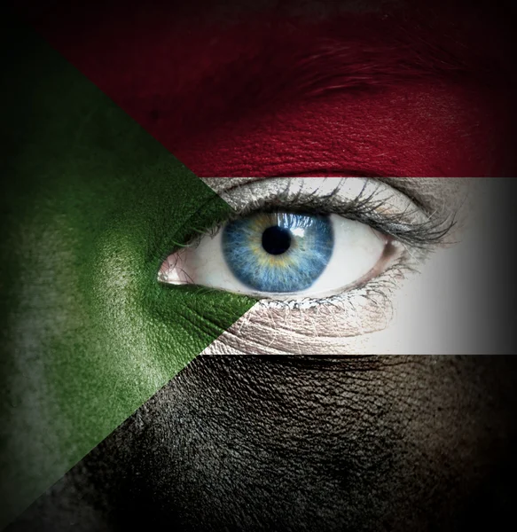 Human face painted with flag of Sudan — Stock Photo, Image