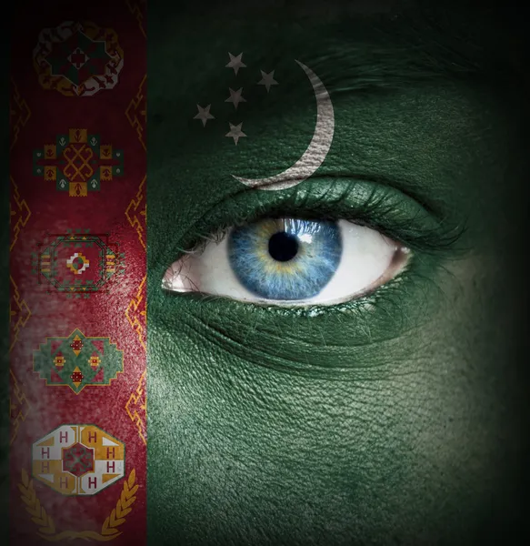 Human face painted with flag of Turkmenistan — Stock Photo, Image