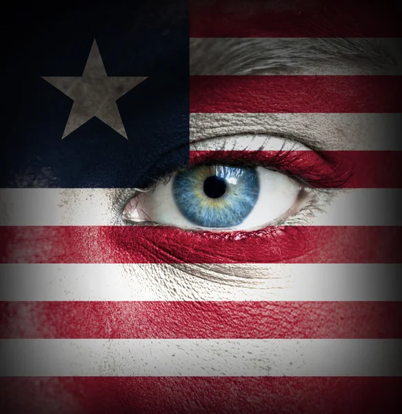 Human face painted with flag of Liberia — Stock Photo, Image