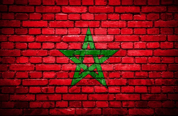 Cihlová zeď s malovanými vlajka Maroka — Stock fotografie