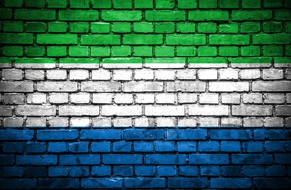 Brick wall with painted flag of Sierra Leone — Stock Photo, Image