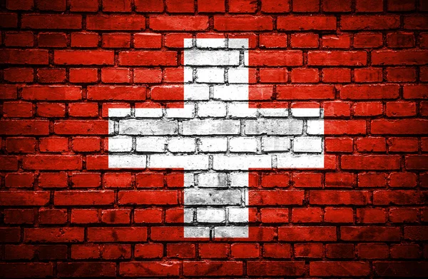 Mur z cegły z malowane flaga Szwajcarii — Zdjęcie stockowe