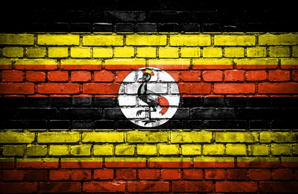 Parede de tijolo com bandeira pintada de Uganda — Fotografia de Stock