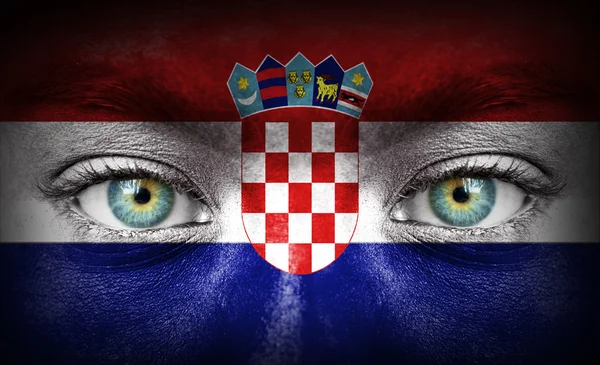 Human face painted with flag of Croatia — Stock Photo, Image