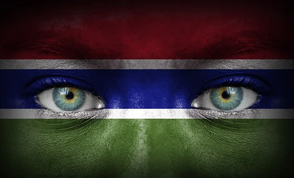 Human face painted with flag of Gambia — Stock Photo, Image