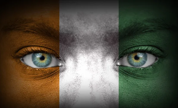 Human face painted with flag of Ivory Coast — Stock Photo, Image