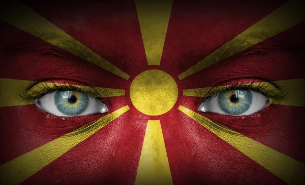 Human face painted with flag of Macedonia — Stock Photo, Image