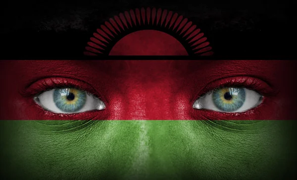 Menselijk gezicht beschilderd met vlag van malawi — Stockfoto