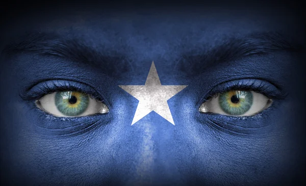 Human face painted with flag of Somalia — Stock Photo, Image