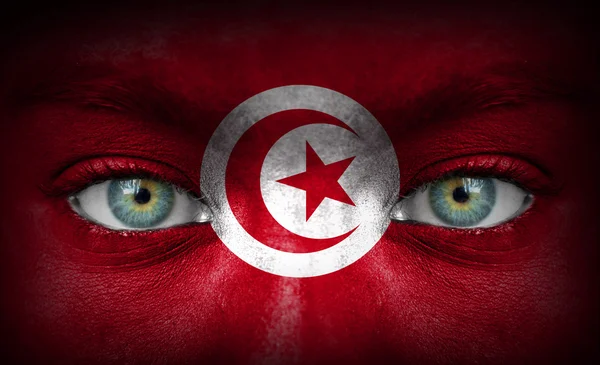 Human face painted with flag of Tunisia — Stock Photo, Image