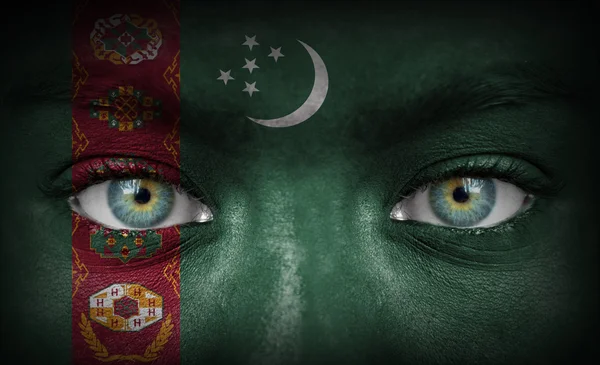 Human face painted with flag of Turkmenistan — Stock Photo, Image