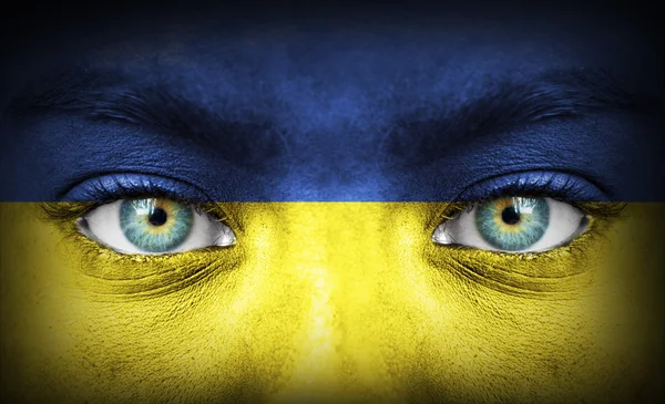 Human face painted with flag of Ukraine — Stock Photo, Image