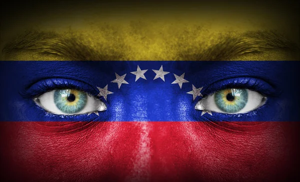 Menselijk gezicht beschilderd met vlag van venezuela — Stockfoto