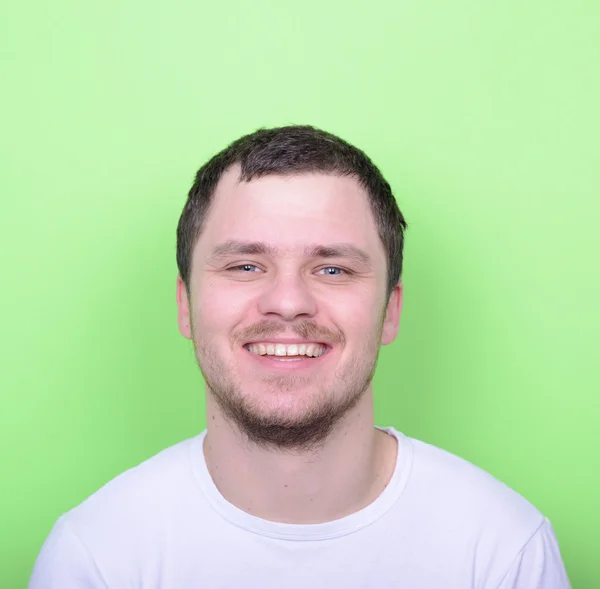 Portrait of handsome man smiling against green background — Stock Photo, Image