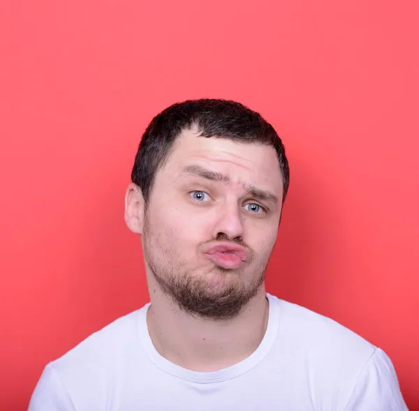 Portrait of man with funny face against red background — Stock Photo, Image