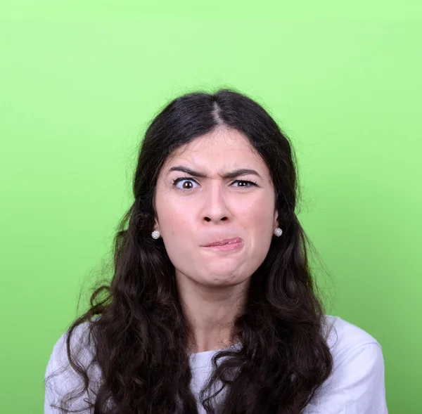 Portrait of girl with funny face against green background — Stock Photo, Image