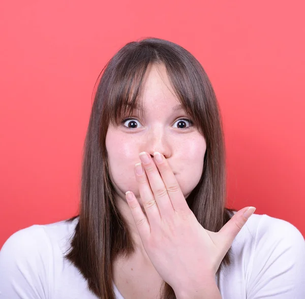 Portrait of amazed girl against red background — Stock Photo, Image