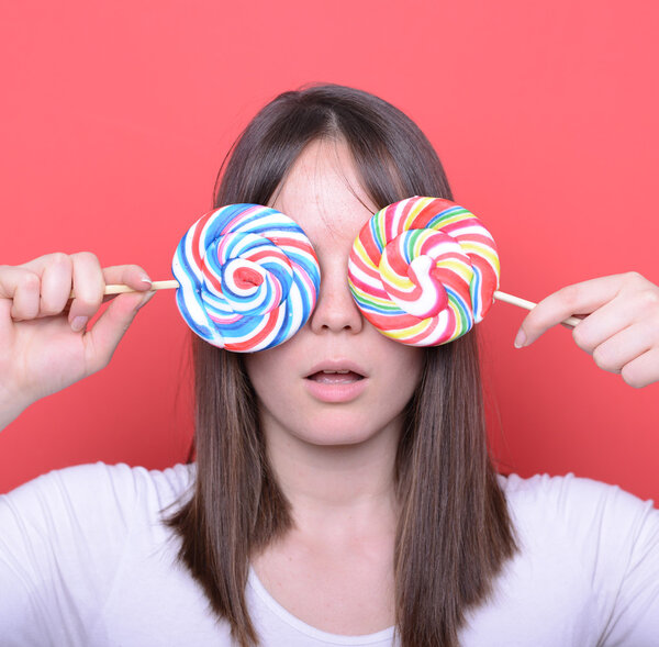 Portrait of woman with two big colorful lollipops