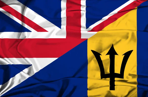 Mávání vlajkou Barbadosu a uk — Stock fotografie