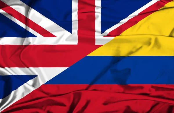 Vlající vlajka Kolumbie a uk — Stock fotografie
