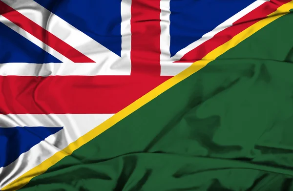 Waving flag of Solomon Islands and UK — Stock Photo, Image