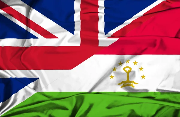 Waving flag of Tajikistan and UK — Stock Photo, Image