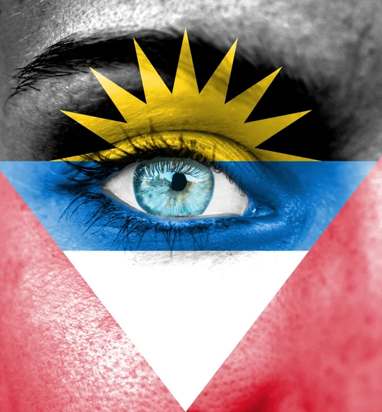 Femme visage peint avec le drapeau d'Antigua-et-Barbuda — Photo