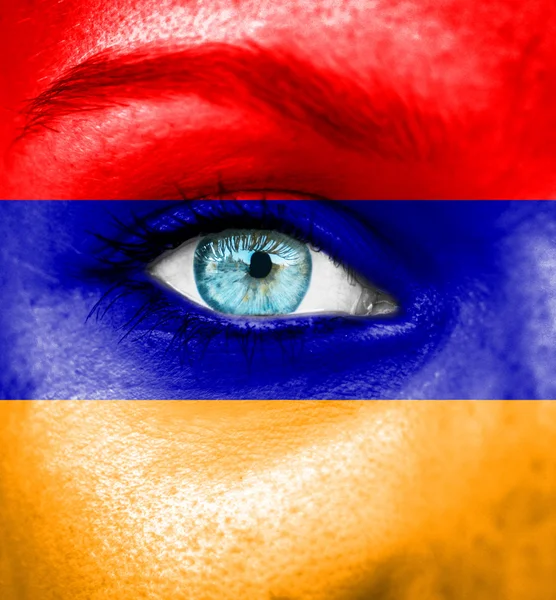 Woman face painted with flag of Armenia — Stock Photo, Image