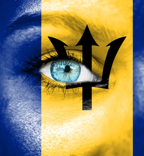 Woman face painted with flag of Barbados — Stock Photo, Image